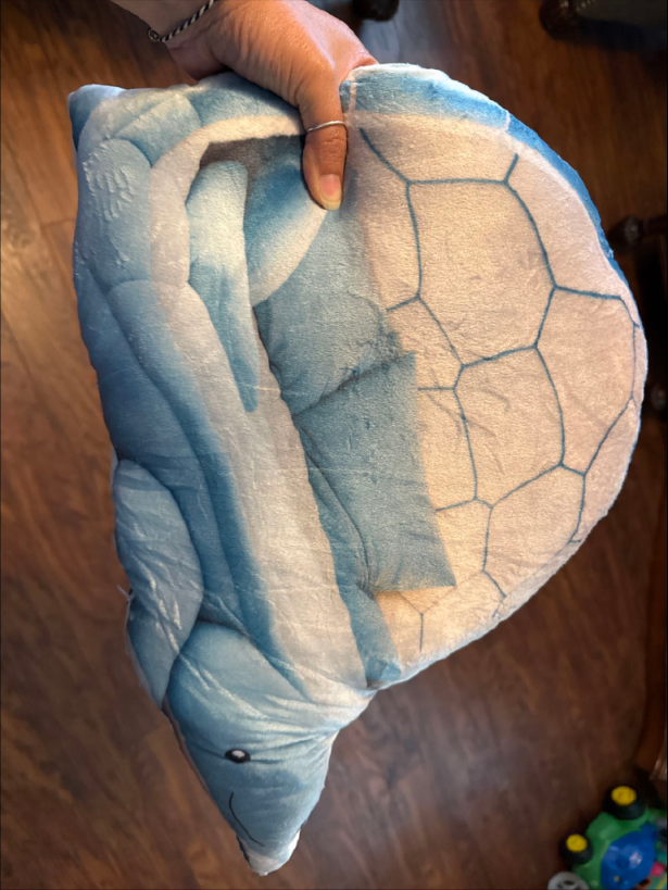Customer photo (flagged for review) of the Giant Blue Turtle Nest flat plush shaped pillow
